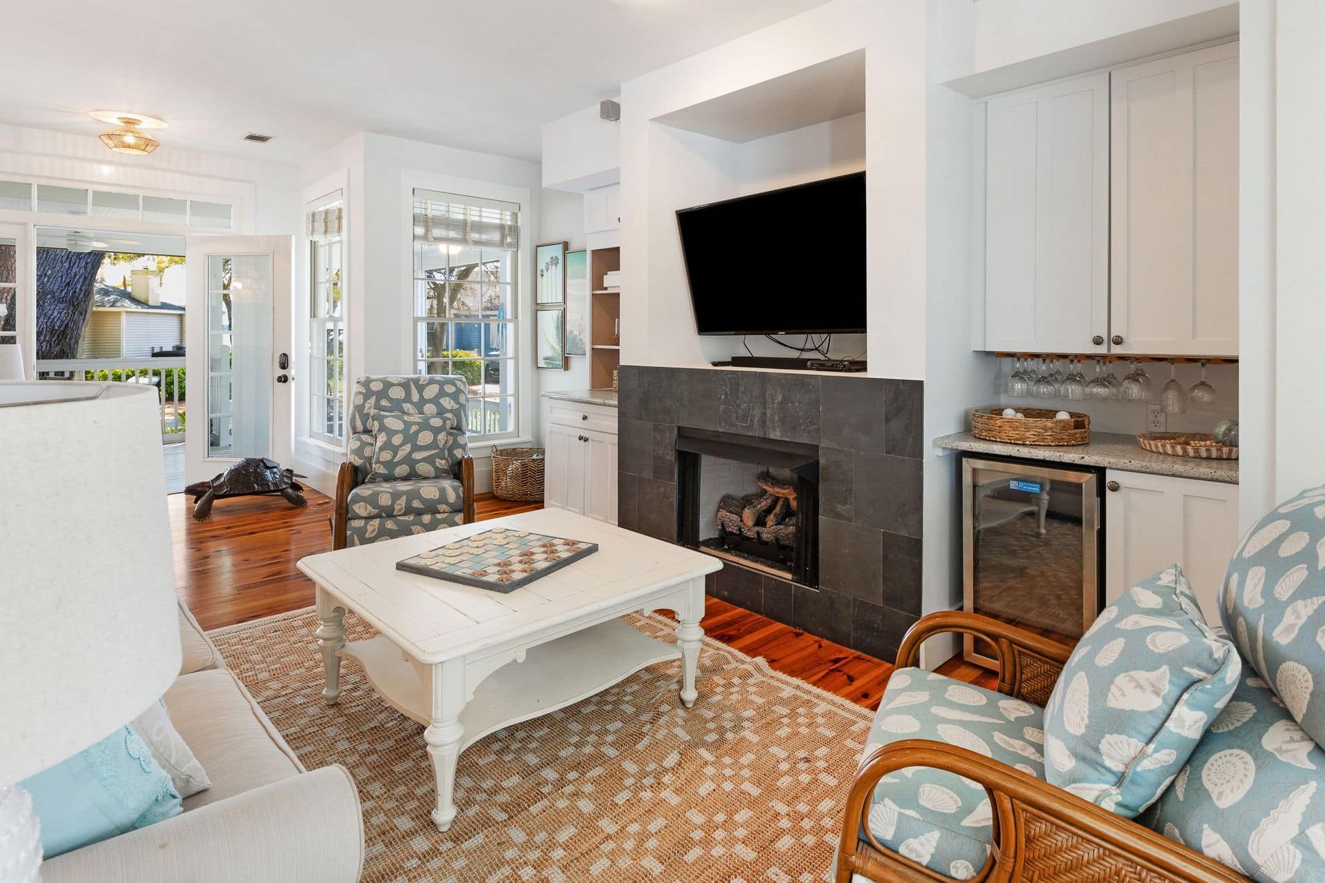 A living room with a fireplace and a flat screen tv