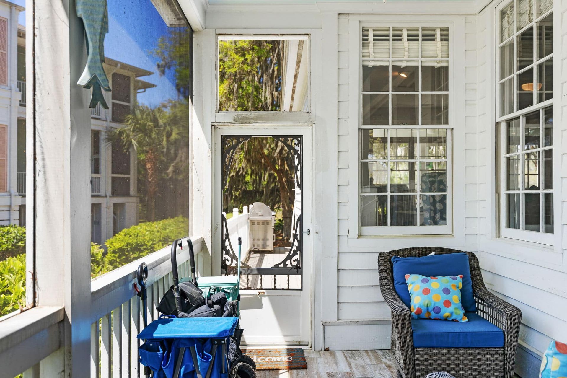 A porch with a chair and a wagon on it.