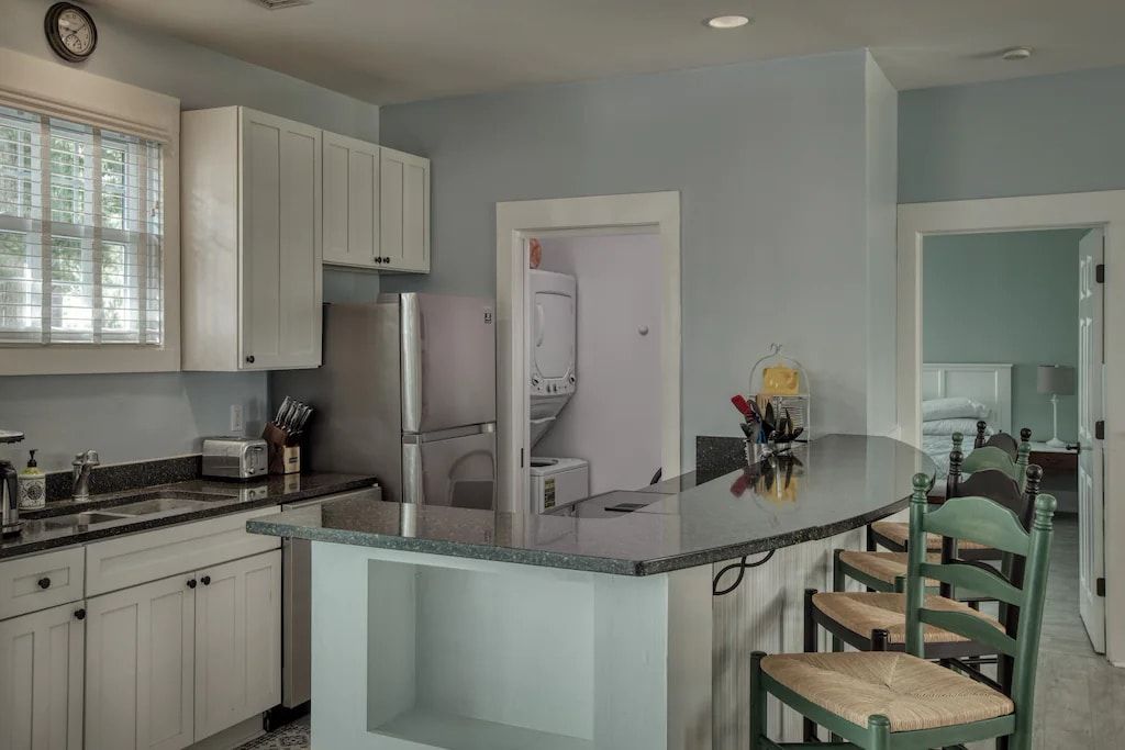 A kitchen with white cabinets and granite counter tops