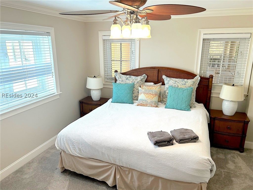 A bedroom with a day bed and a chair.
