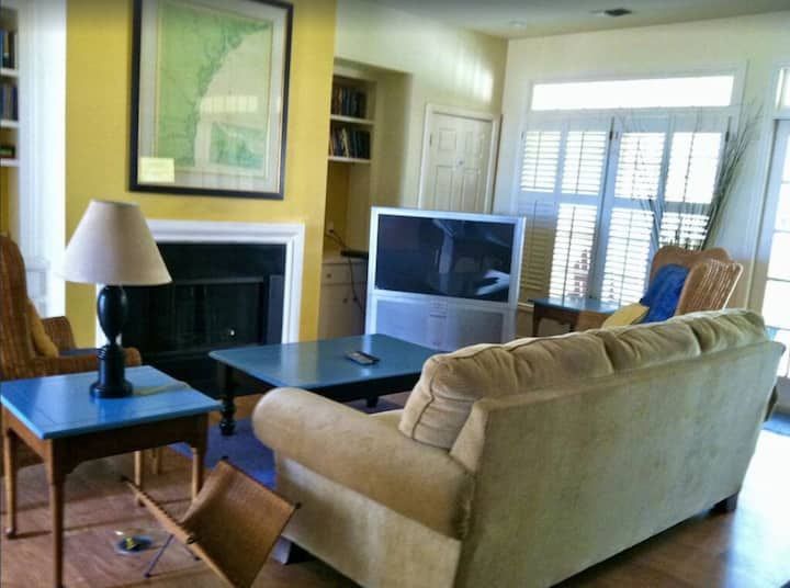 A living room with a couch and a flat screen tv
