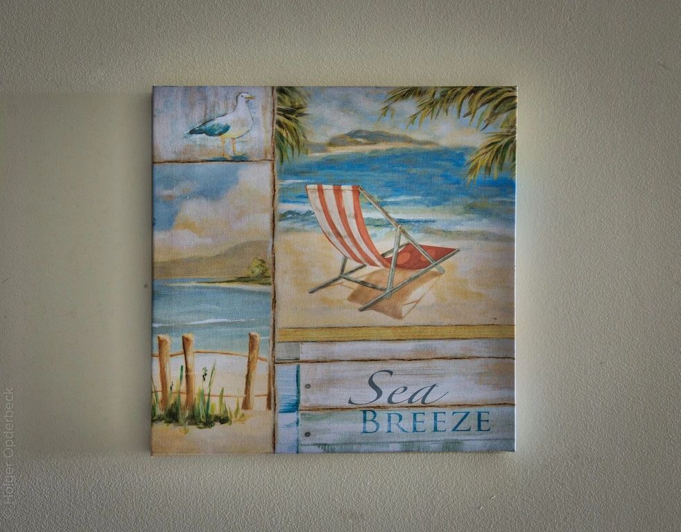 A painting of a beach chair with the words sea breeze on the bottom