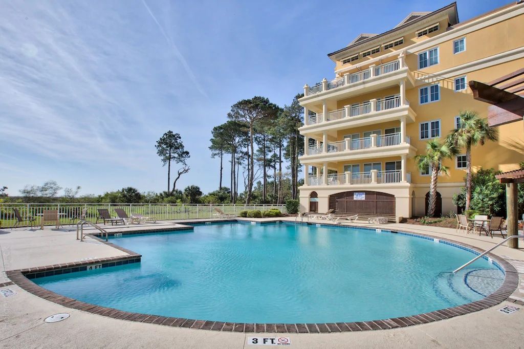 A large swimming pool in front of a large building