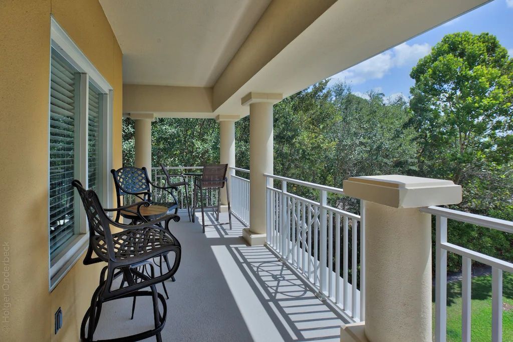 A balcony with a table and chairs on it