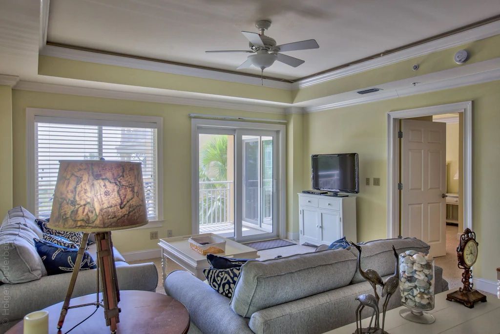 A living room with a couch , table , lamp and television.