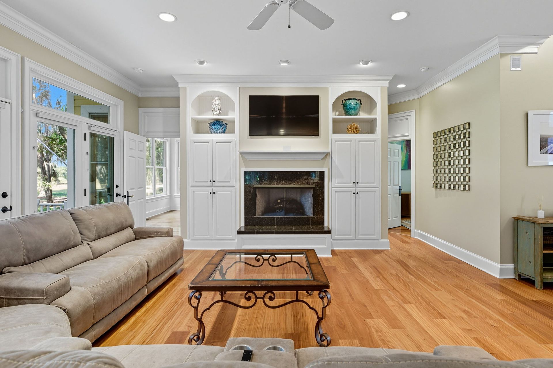 A dining room with a table and chairs and a large window.