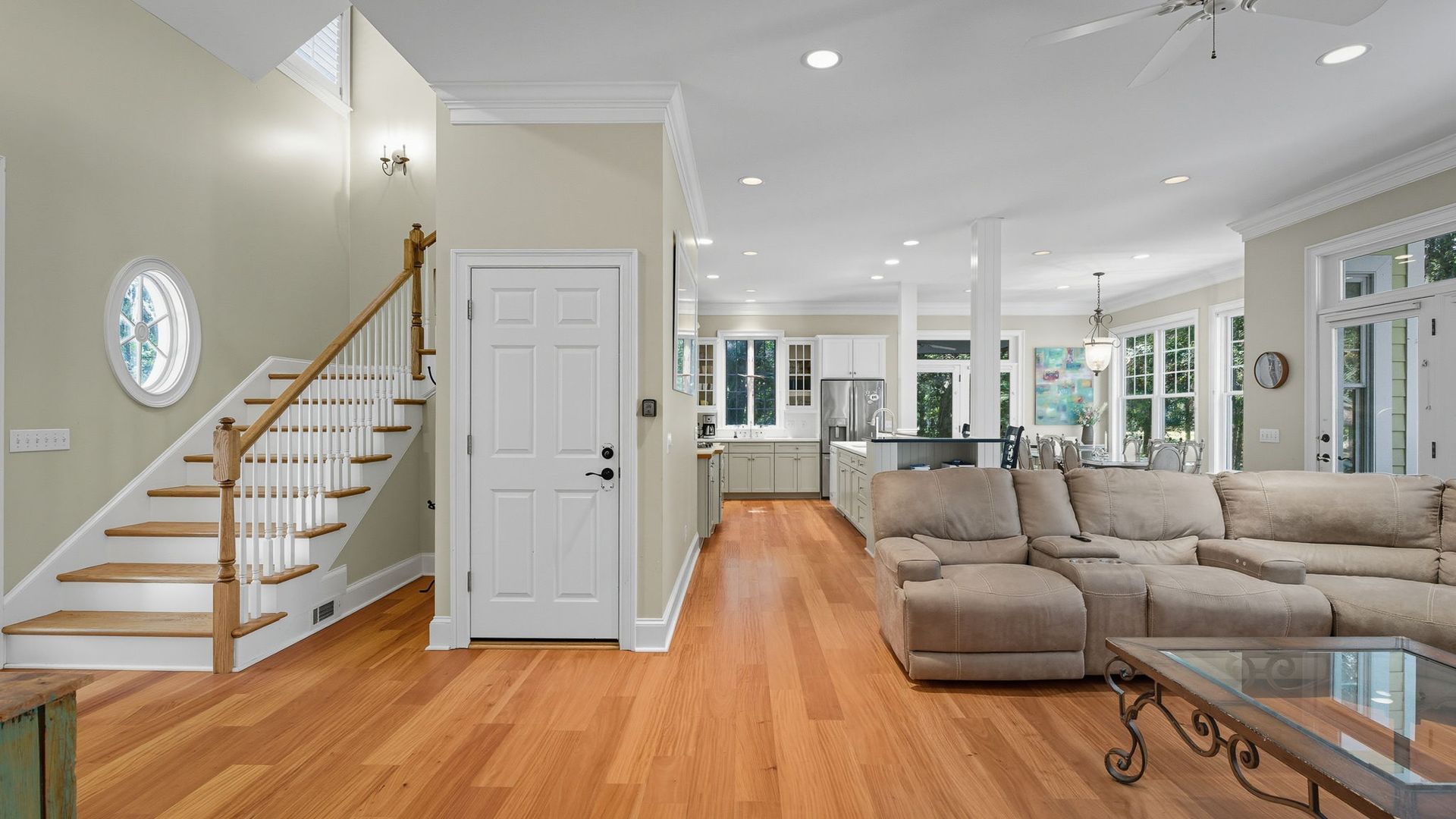 A kitchen with a sink and a ceiling fan