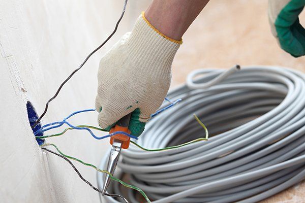 Worker Puts the Wires in the Wall — West Maryland — Brandenburg Electric Inc Worker Puts the Wires in the Wall — West Maryland — Brandenburg Electric Inc