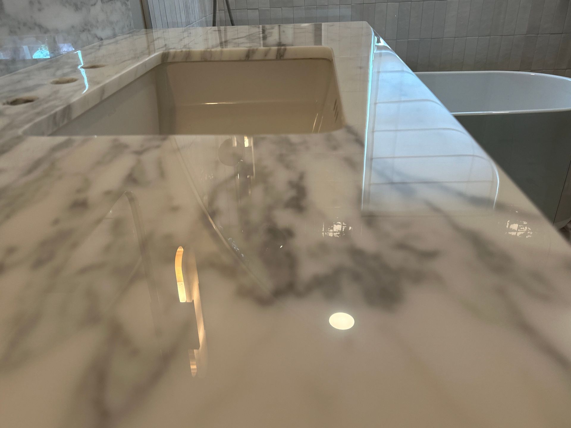 Modern bathroom featuring a gray and white marble countertop after a MORE® AntiEtch® treatment