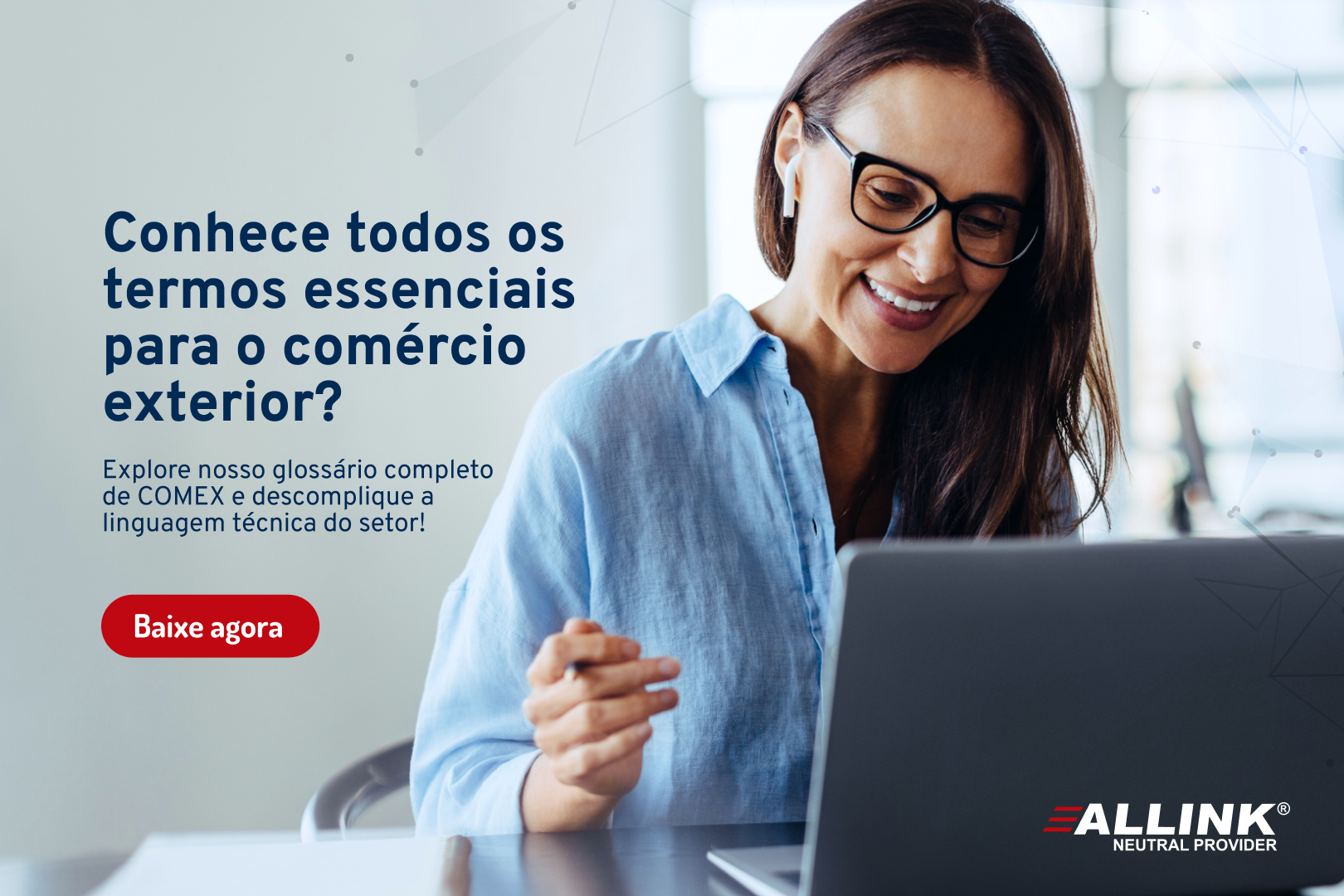 Uma mulher usando óculos está sentada em frente a um laptop.