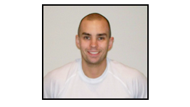 Smiling bald man in a white shirt against a plain light background.