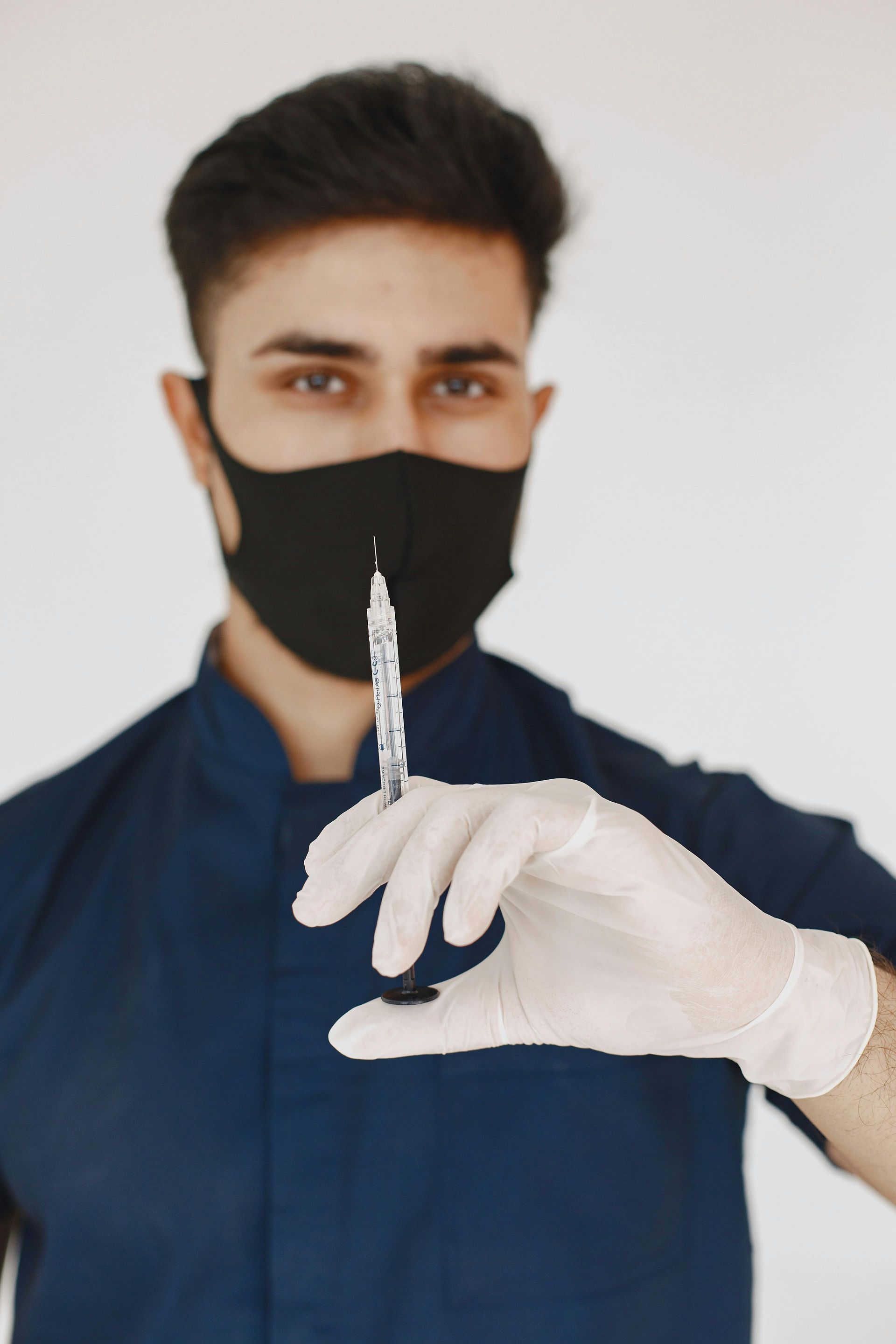 Doctor with syringe preparing hip cortisone injection in Charlotte NC clinic