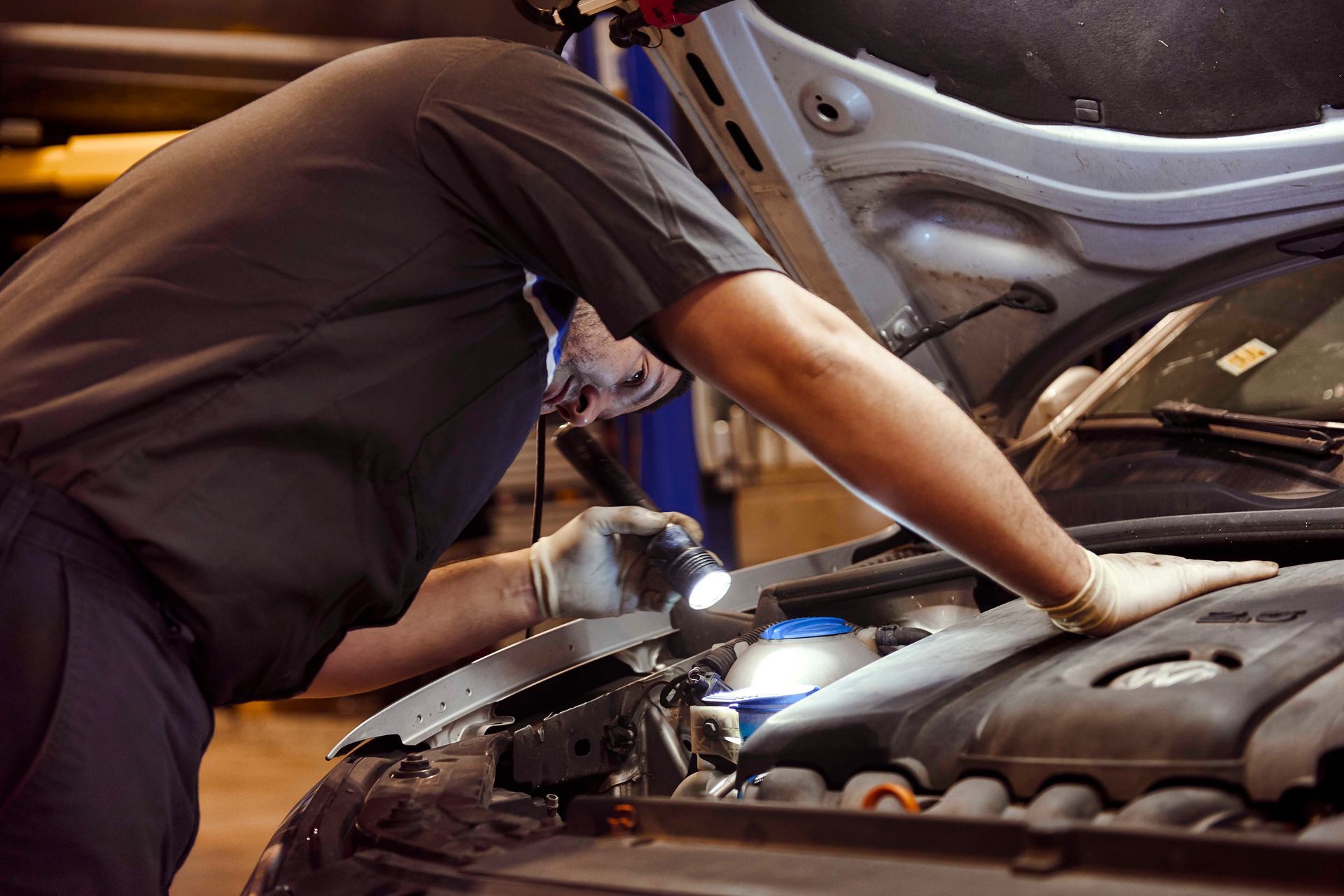 Professional mechanic working on a car engine