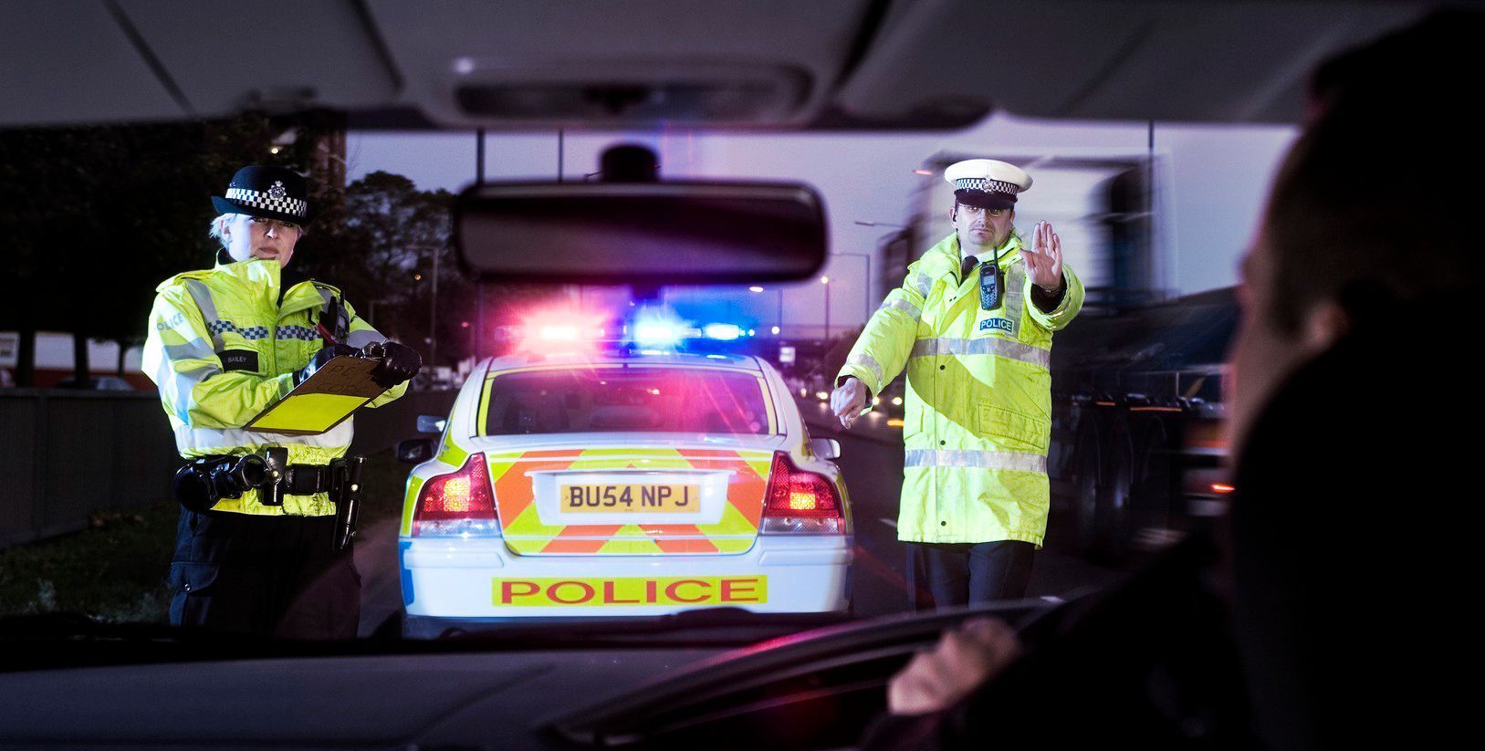 Picture of a police office speaking to someone in a car