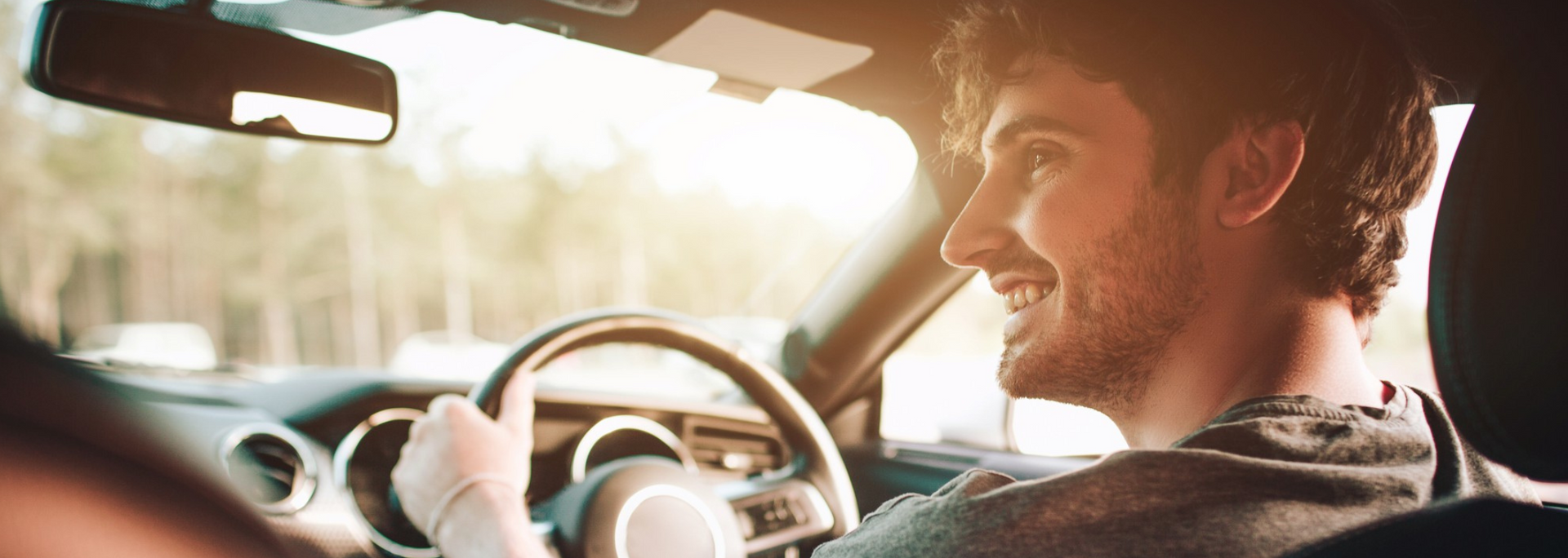 Picture of someone happily driving a car.