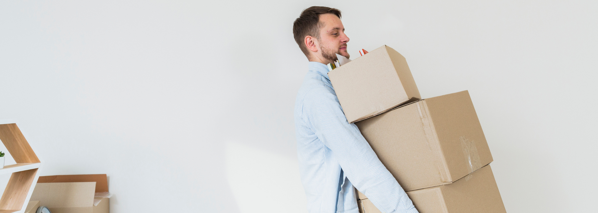 Picture of someone carrying heavy boxes.