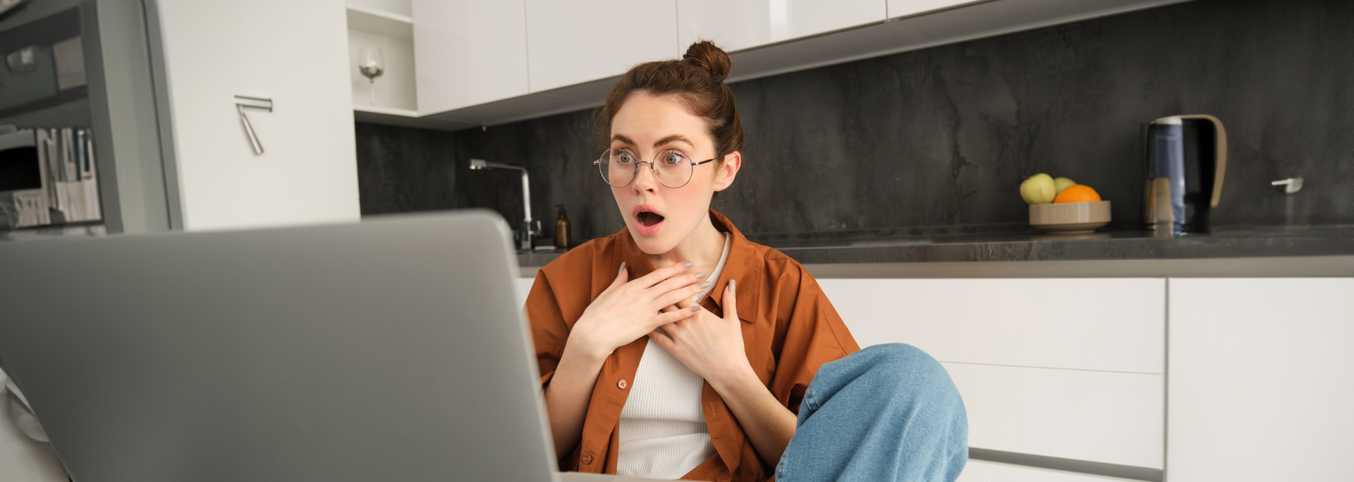 Picture of someone looking shocked at their computer. Picture of someone looking shocked at their computer.