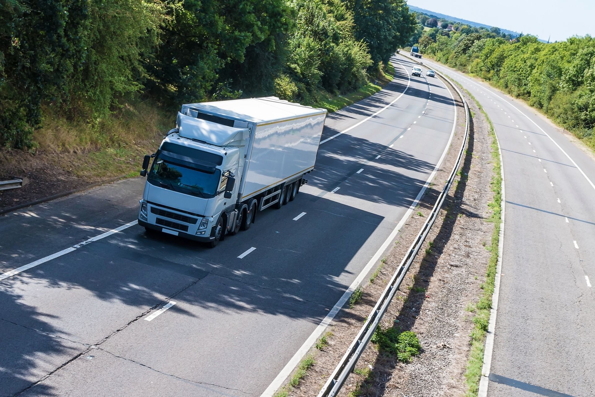 Moving truck driving on highway for long-distance relocation service.
