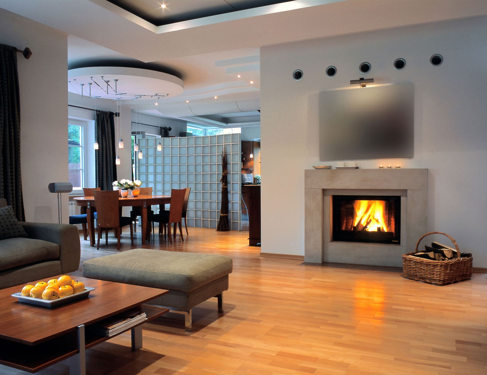 A living room with a fireplace and dining table A living room with a fireplace and dining table