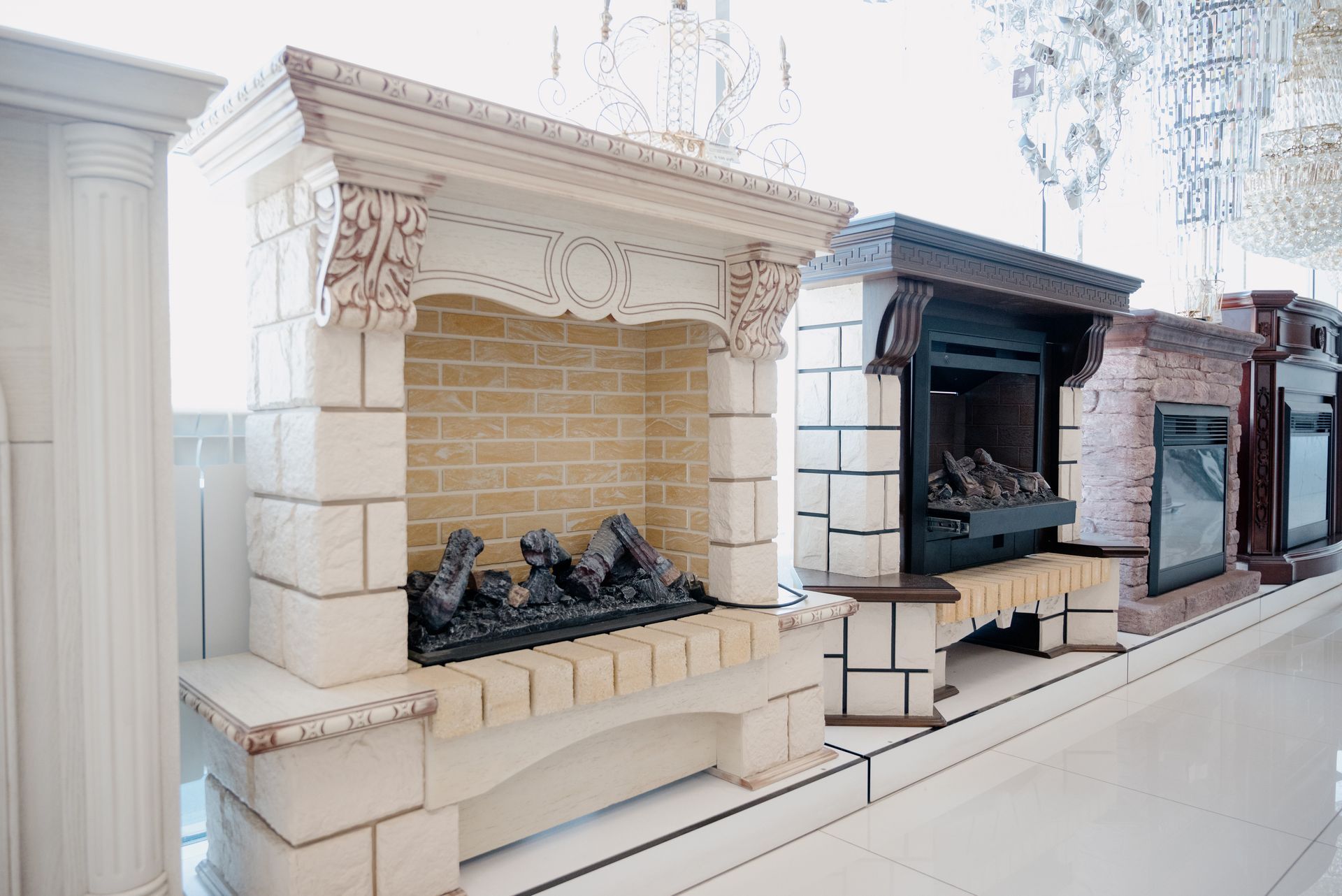 Showroom display of stone fireplace mantels with an electric insert model.