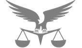 A silhouette of an eagle sitting on top of a scale of justice.