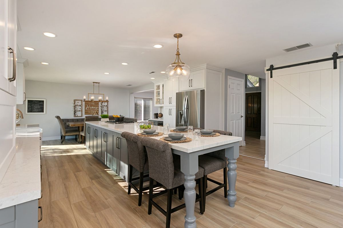 A kitchen with a large island and sliding barn doors.
