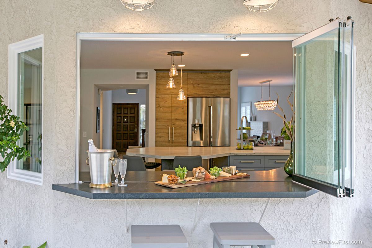 A large kitchen with a large island in the middle of it.