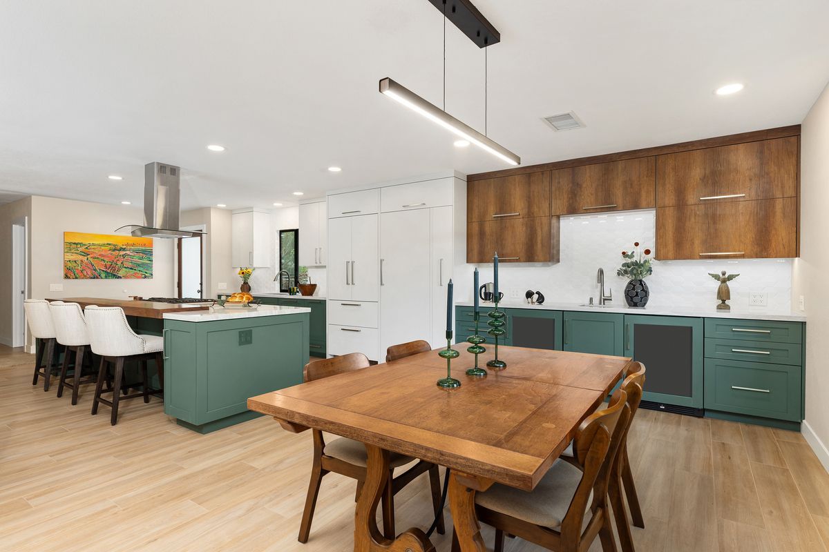 A kitchen with a stove and a window with a cabinet open.