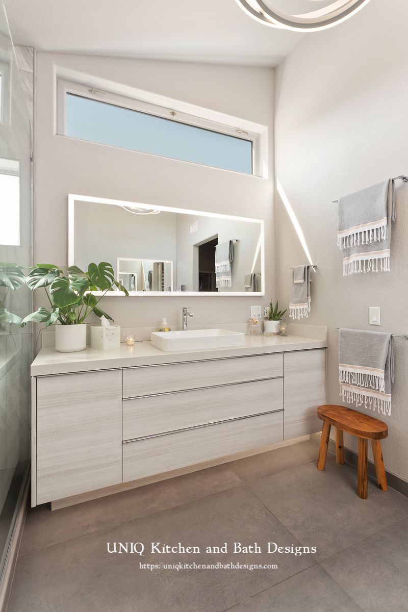 A bathroom with two sinks and a large mirror.