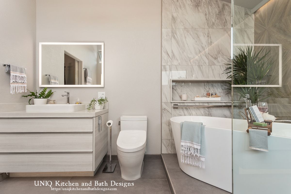 A bathroom with a toilet , sink , and bathtub.