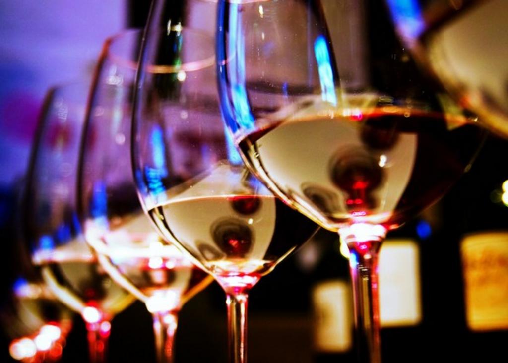 wine glasses lined up with wine