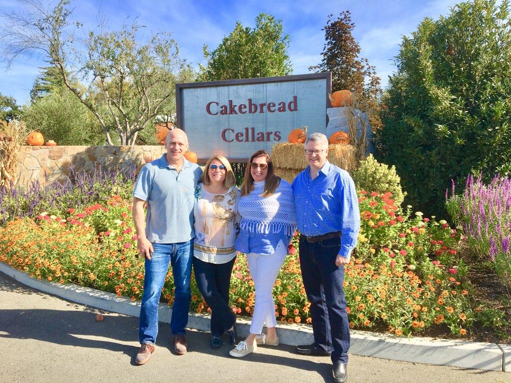 4 people in front of a winery sign
