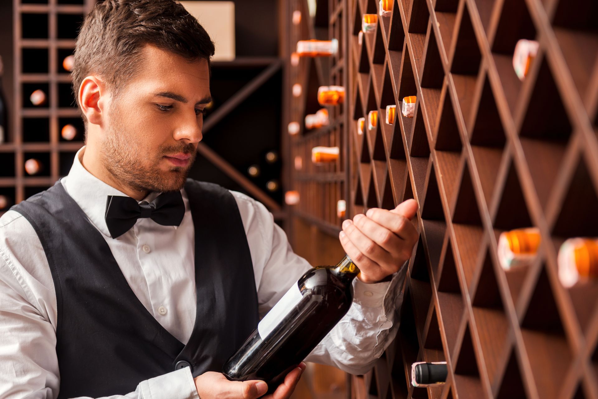 sommelier holding a bottle of wine