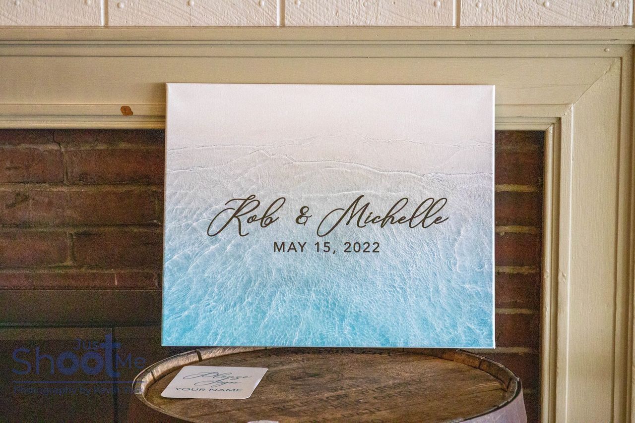 A canvas sign with a blue ocean gradient background reads 