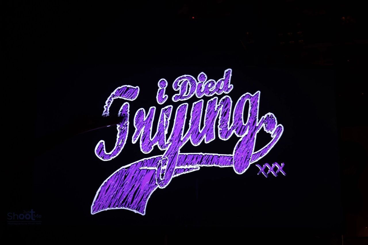 Purple graffiti-style text on a black background reads 