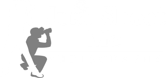 A gray silhouette of a person crouching and looking through binoculars.