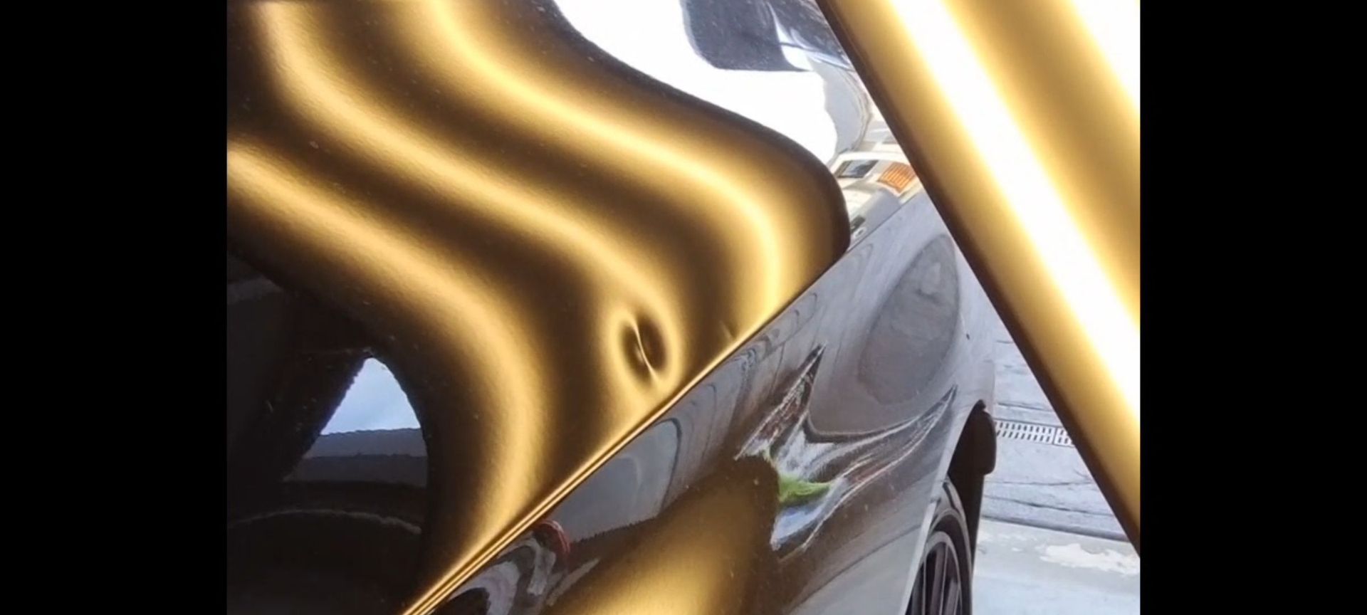 a close up of a car with a dent in it