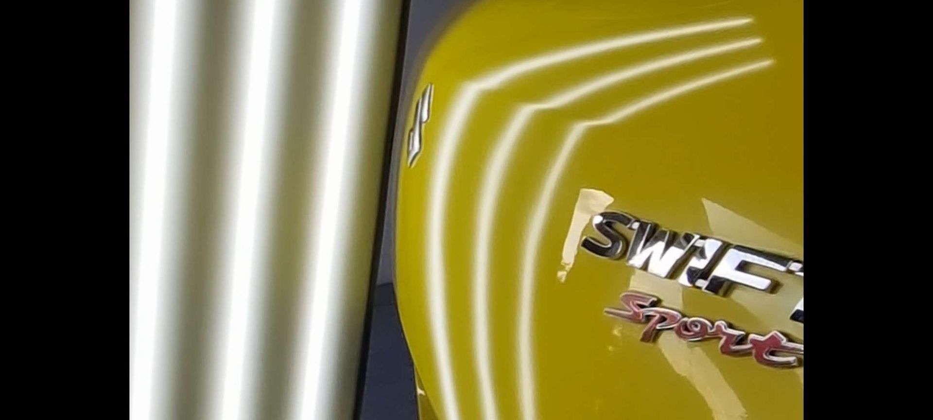 a yellow car gone through the dent removal process