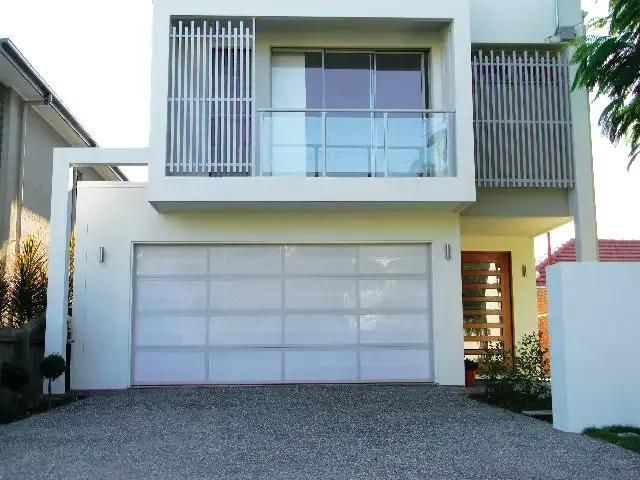 A White House with A White Garage Door and A Balcony — Illawarra Garage Doors in Vincentia, NSW