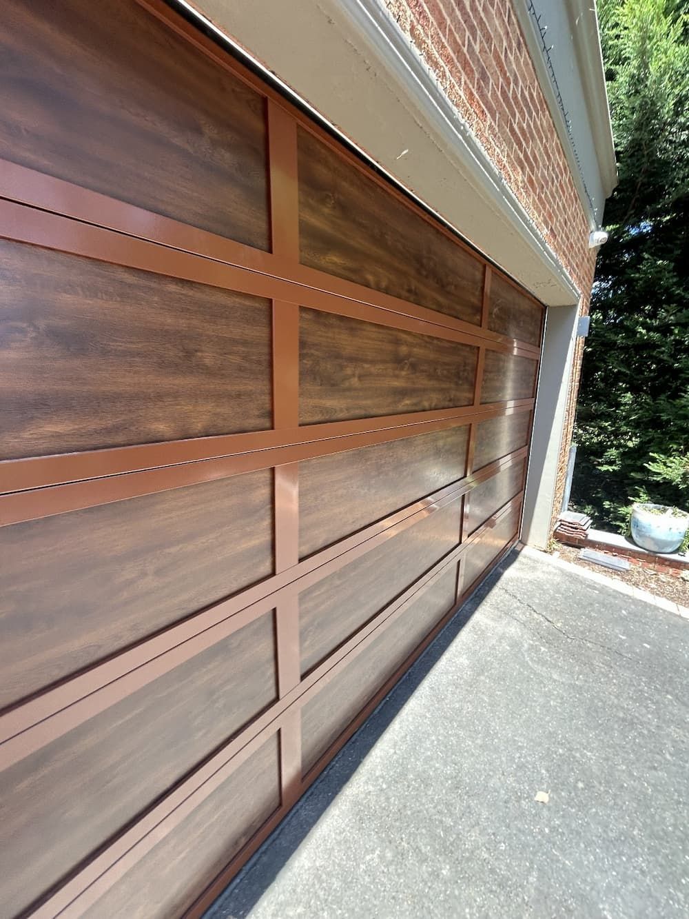 A White Garage Door with Three Windows on A Brick Wall — Illawarra Garage Doors in Albion Park Rail, NSW