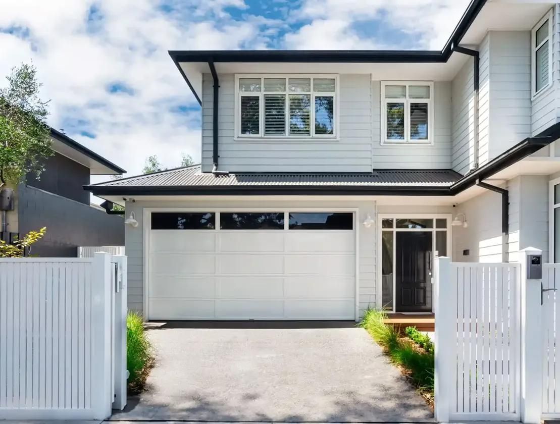 A White House with A White Garage Door and A White Gate — Illawarra Garage Doors in Albion Park Rail, NSW
