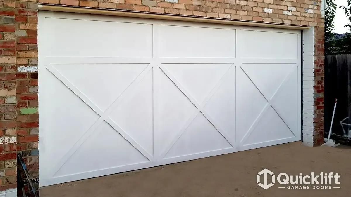 A White Garage Door Is Sitting on Top of A Brick Wall — Illawarra Garage Doors in Albion Park Rail, NSW