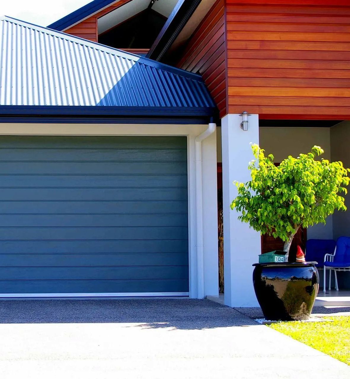 There Are Two Garage Doors on The Side of A Building — Illawarra Garage Doors in Albion Park Rail, NSW