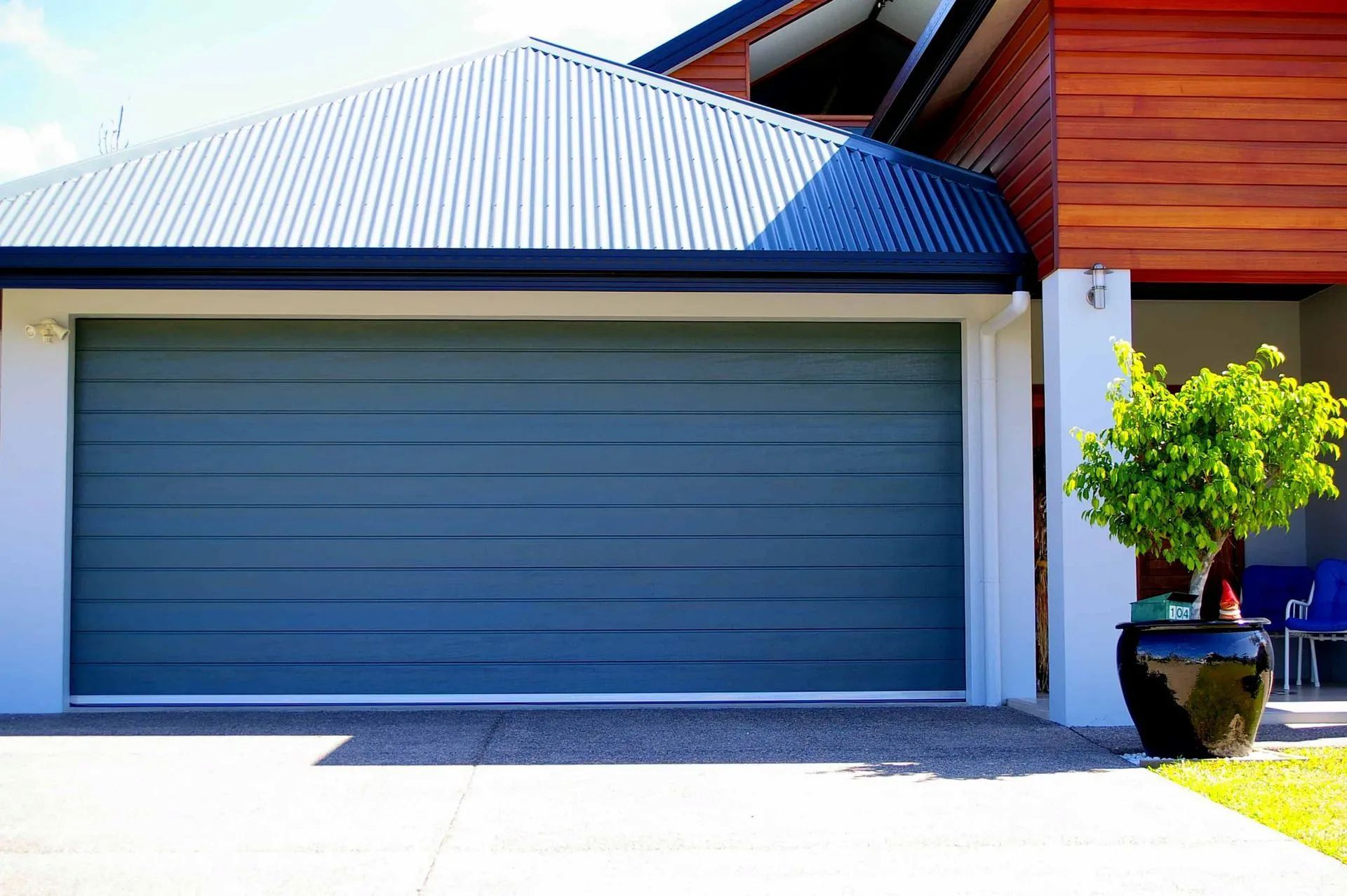 A Large Wooden Garage Door with A Lot of Windows — Illawarra Garage Doors in Vincentia, NSW