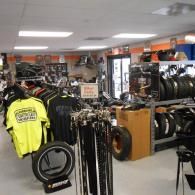 Bike shop interior with racks of bicycles and cycling gear, including a bright yellow jersey in the foreground