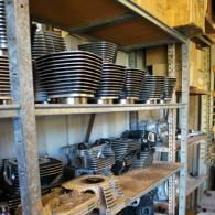 Shelves stacked with rows of black-and-white ceramic bowls in a storage area