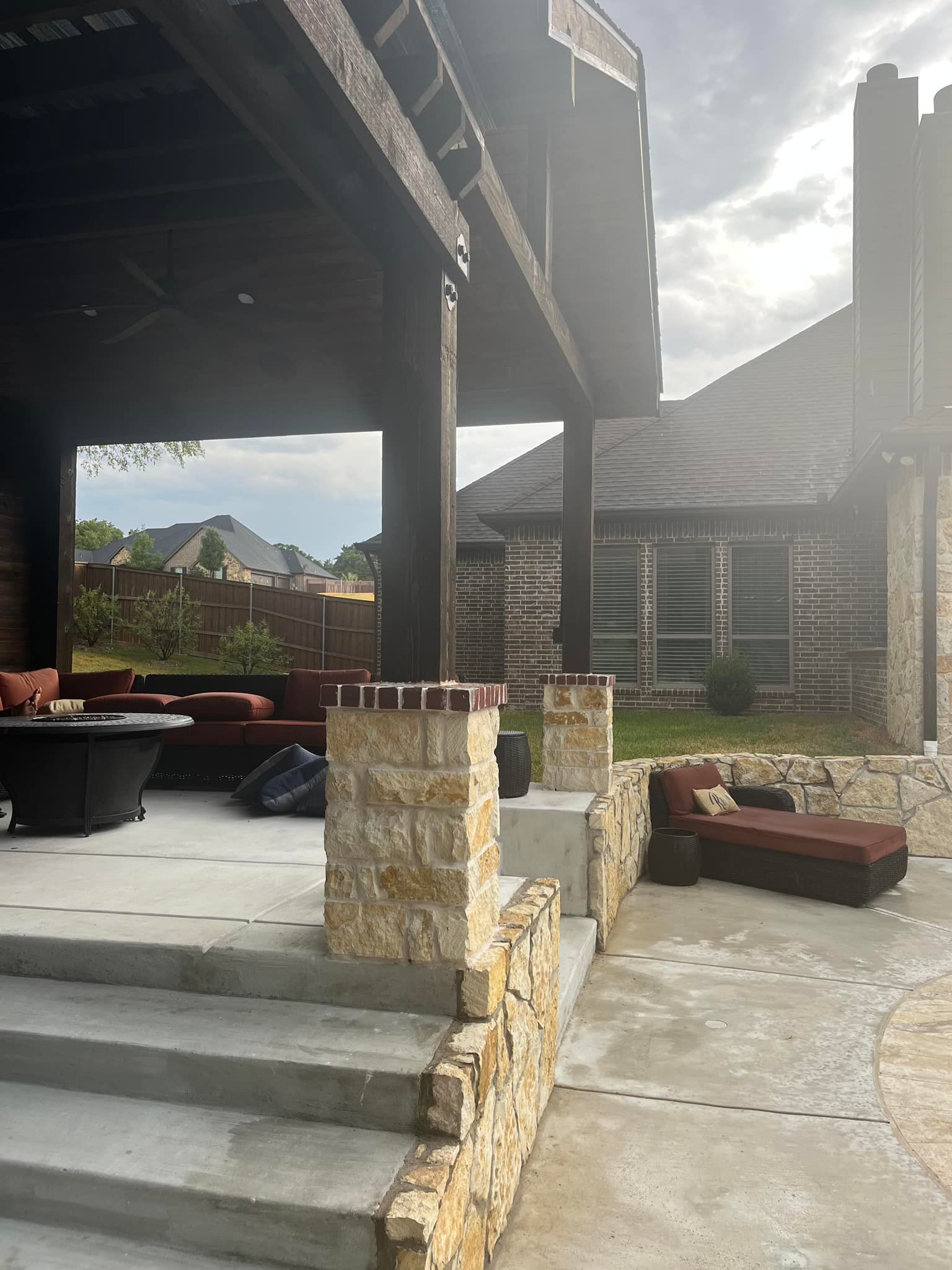 Outdoor patio with stone steps, shaded seating, and a mountain view in the background