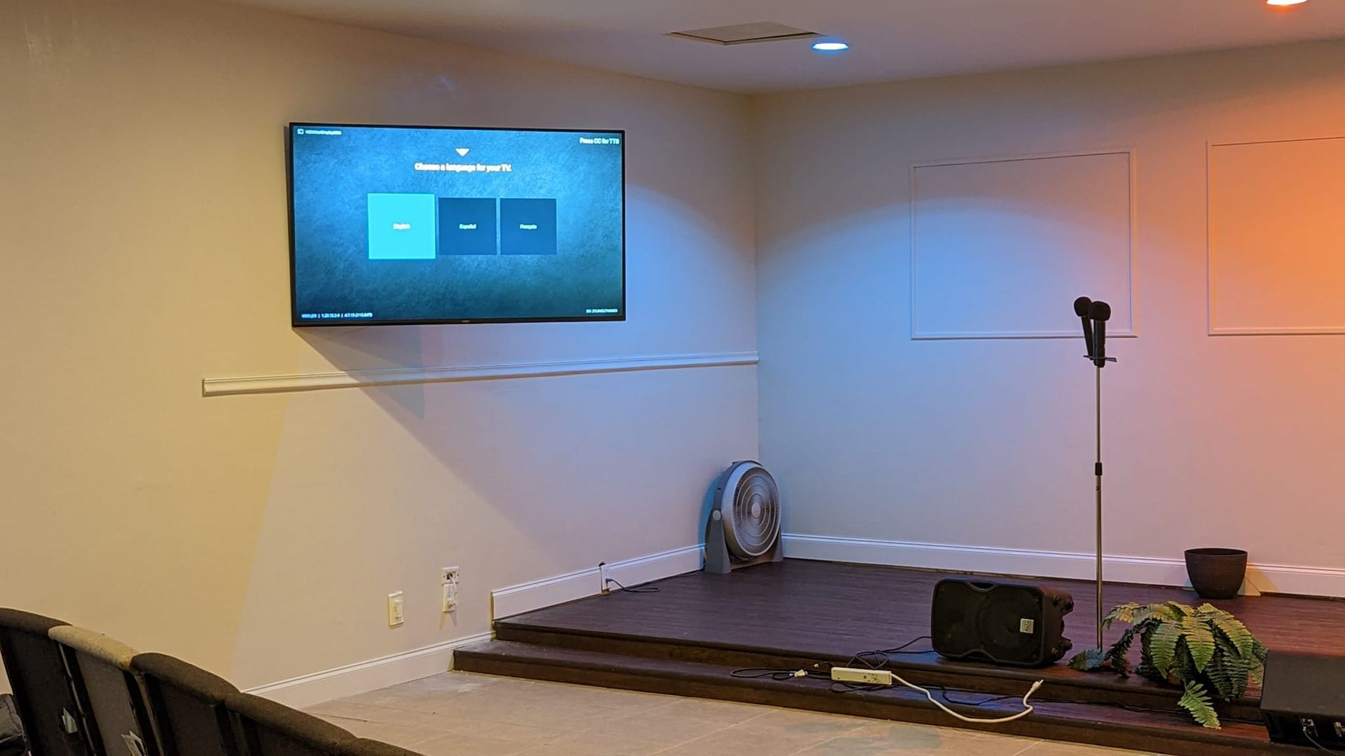 A room with a large flat screen tv mounted on the wall.