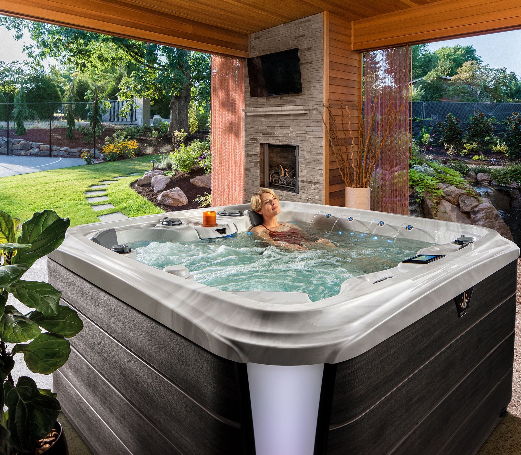 Hot tub in a Eugene backyard with steam rising in the cool air