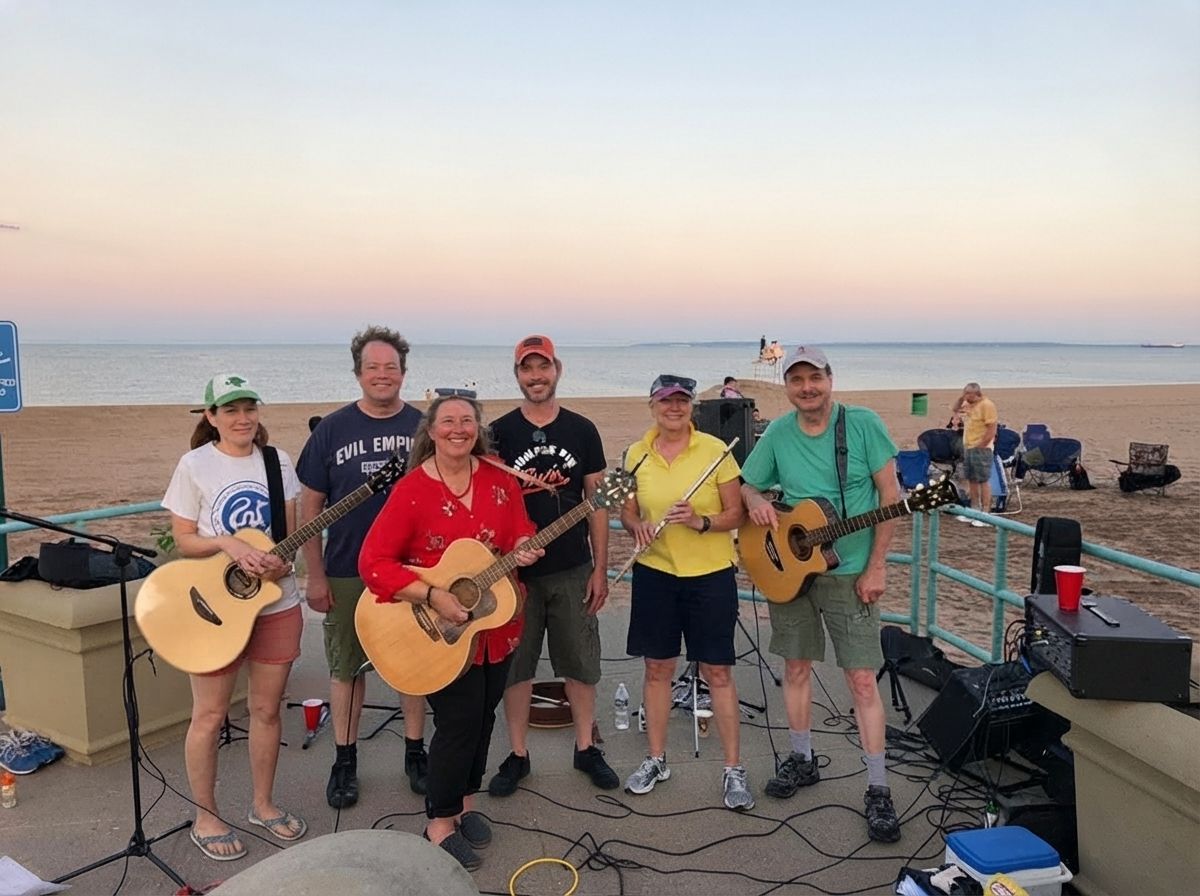 Six musicians performing on a seaside promenade at sunset, with guitars, a red shirt, and beach backdrop Six musicians performing on a seaside promenade at sunset, with guitars, a red shirt, and beach backdrop